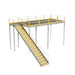 Warehouse mezzanine stairway with yellow railing, constructed of metal and bar grating, compliant with IBC standards.