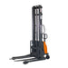 Forklift truck with a front handle, designed as a semi-electric straddle stacker with a 3,300 lbs capacity and 138" height.