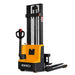 EKKO EB12EA full powered straddle stacker, featuring yellow and black forks, with a 3000 lb lifting capacity.