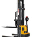 EKKO EB13E straddle stacker forklift with yellow and black forks, capable of lifting 2800 lbs.