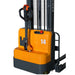 A powered straddle stacker forklift with a handle, designed for lifting loads up to 3000 lbs in various environments.