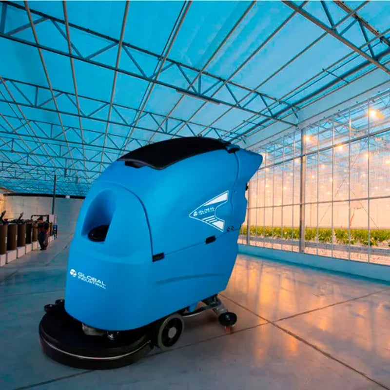 Global Industrial battery-powered floor scrubber cleaning a hard floor in a large indoor space.