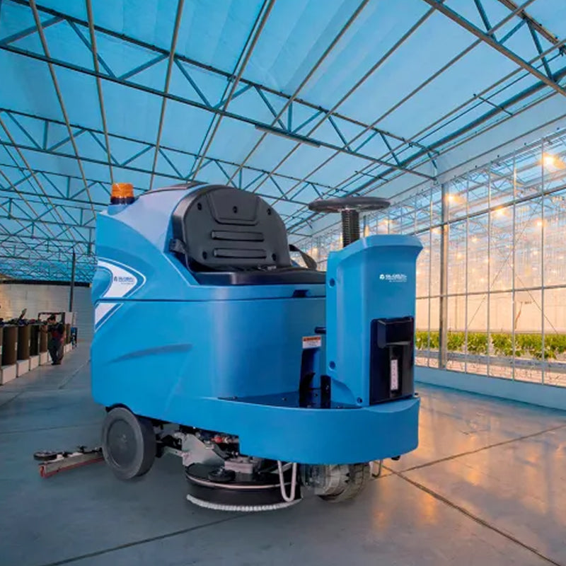 Global Industrial ride-on floor scrubber shown cleaning a large indoor floor.