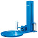 Blue stretch wrap machine shown with its turntable, upright mast, and film carriage for wrapping pallet loads.