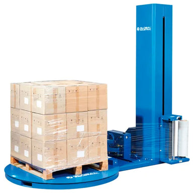 Blue stretch wrap machine with a pallet load on the turntable, showing the film carriage beside the wrapped load.