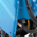 Close-up of the scrubber’s power cord and hose connections on the machine body.