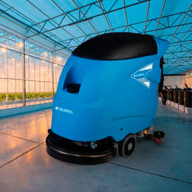 Blue Global Industrial floor scrubber shown cleaning a hard floor in a large indoor space.