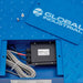 Close-up beneath the scale platform showing its load cell wiring and Global Industrial branding.